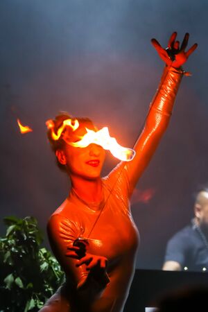 Brezje, Croatia - 19th July, 2019 : A woman juggling with a fire on the stage on the Forestland, ultimate forest electronic music festival located in Brezje, Croatia.のeditorial素材