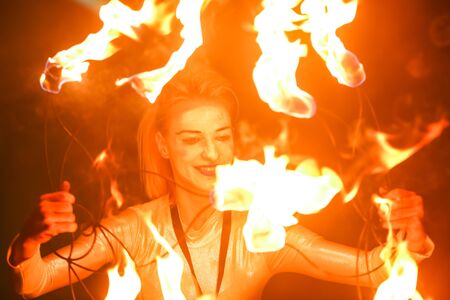 Brezje, Croatia - 19th July, 2019 : A woman juggling with a fire on the stage on the Forestland, ultimate forest electronic music festival located in Brezje, Croatia.のeditorial素材