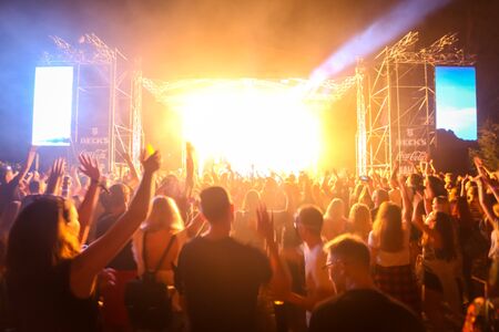 Brezje, Croatia - 20th July, 2019 : Rear view of the crowd with main stage in the background on the...