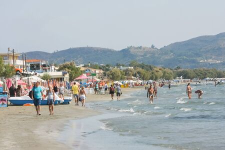 Laganas, Zakynthos, Greece - October 3, 2011 : Beach with tourists on the coast of Laganas resort in...