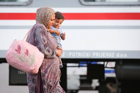 Dugo Selo,Croatia - September 17, 2015 : A Syrian woman with a child walking on the railway after...