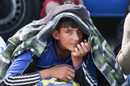 Bregana, Slovenia - September 20, 2015 : A front view of a Syrian boy looking at the camera on the...