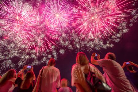 People sightseeing festival of fireworks on coast of Sava river in Zagreb, Croatia.