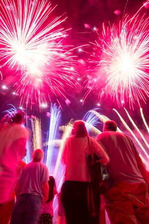 People sightseeing festival of fireworks on coast of Sava river in Zagreb, Croatia.