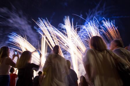 People sightseeing festival of fireworks on coast of Sava river in Zagreb, Croatia.