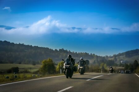 Front view of motorbikes driving on the two way road with landscape of Gorski Kotar in Croatia.の写真素材