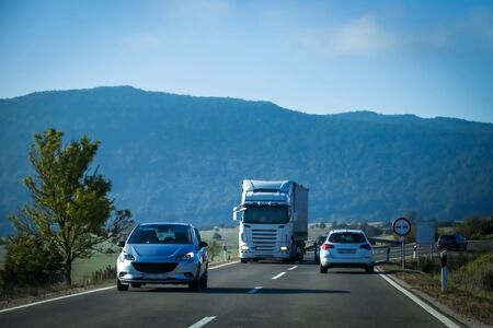 Cars and truck driving on the two way road with landscape of Gorski Kotar in Croatia.