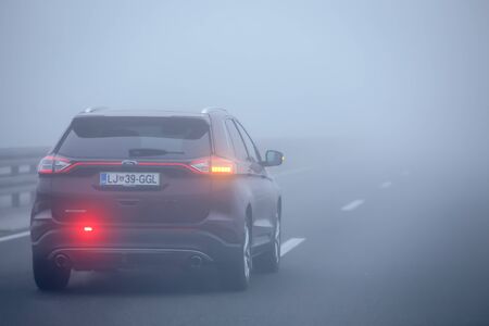 Zagreb, Croatia - 27th October, 2019 : Traffic on the highway during thick morning fog.のeditorial素材