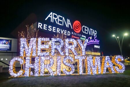Zagreb, Croatia - December 28, 2019 : A big illuminated sign Merry Christmas in front of shopping mall Arena Zagreb in Zagreb, Croatia.のeditorial素材