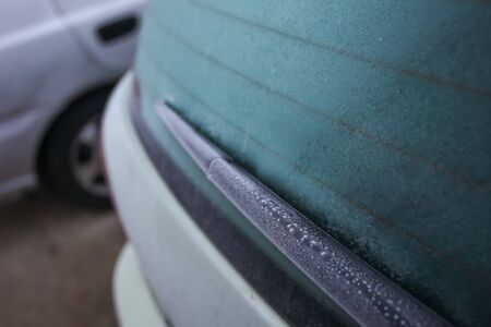 Detail of a frozen rear window of a car with wiper.の写真素材