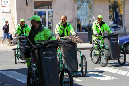 Zagreb, Croatia - April 17, 2020 : A group of garbage man driving bikes with trash cans on it in downtown of Zagreb, Croatia.のeditorial素材