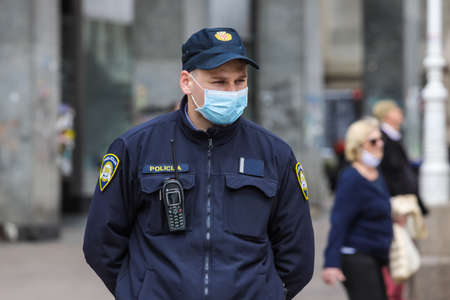 Zagreb, Croatia - 01 May, 2020 : Policeman wears a protective medicine mask because of coronavirus...