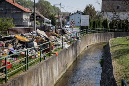 Zagreb, Croatia - 12 April, 2020 : Big pile of bulky waste and garbage next to the Mirosevecka street with streamlet in Zagreb, Croatia.のeditorial素材