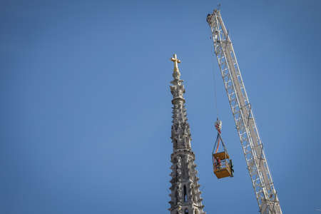 Zagreb, Croatia - April 15, 2020 : Workers with tall cranes are preparing to separate top of the Zagreb Cathedral tower that was damaged by the earthquake of 5.5 on the Richter scale one month ago.のeditorial素材