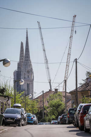 Zagreb, Croatia - April 15, 2020 : View on tall cranes that are preparing to separate top of the Zagreb Cathedral tower that was damaged by the earthquake of 5.5 on the Richter scale one month ago.のeditorial素材