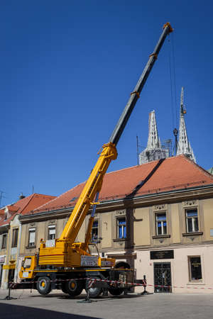 Zagreb, Croatia - April 16, 2020 : Workers with cranes fixing the roofs that was damaged by the...
