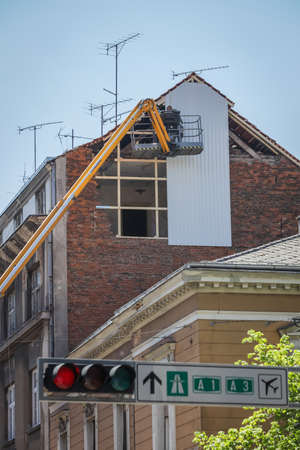 Zagreb, Croatia - April 16, 2020 : Workers with cranes fixing the roofs that was damaged by the earthquake of 5.5 on the Richter scale one month ago.のeditorial素材