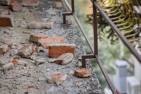 Scattered and damaged bricks on the balcony of the house after a strong earthquake of 5.5 on the Richter scale one month ago in Zagreb, Croatiaの写真素材
