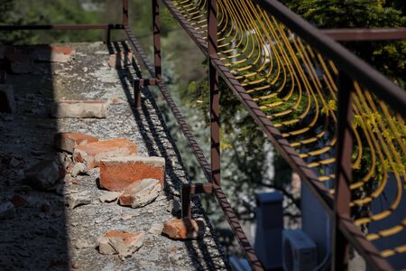 Scattered and damaged bricks on the balcony of the house after a strong earthquake of 5.5 on the Richter scale one month ago in Zagreb, Croatiaの写真素材