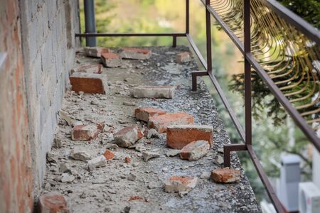 Scattered and damaged bricks on the balcony of the house after a strong earthquake of 5.5 on the Richter scale one month ago in Zagreb, Croatiaの写真素材