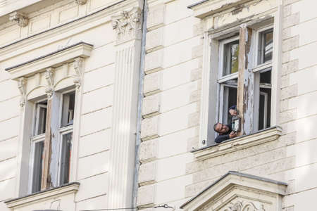Zagreb, Croatia - 15 April, 2020 : Worker fixing wooden window on a damage building in downtown after a strong earthquake of 5.5 on the Richter scale in Zagreb, Croatia.のeditorial素材