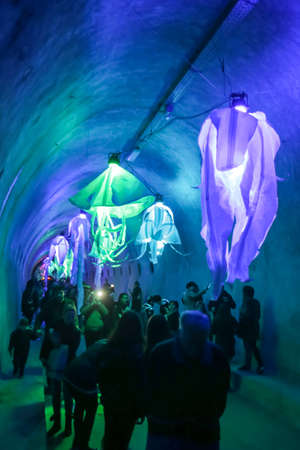 Zagreb, Croatia - 16 March, 2018 : Festival of lights. People walking through a lighted tunnel Gric with lighted colorful abstract chandeliers in the center of Zagreb.のeditorial素材
