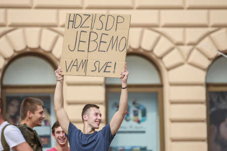 Zagreb, Croatia - 14. September, 2018 : Man holding sign against against the ruling political party Hdz and the opposition SDP on the protest on Ban Jelacic Square in Zagreb, Croatia.のeditorial素材