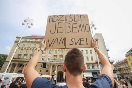 Zagreb, Croatia - 14. September, 2018 : Man holding sign against against the ruling political party Hdz and the opposition SDP on the protest on Ban Jelacic Square in Zagreb, Croatia.のeditorial素材