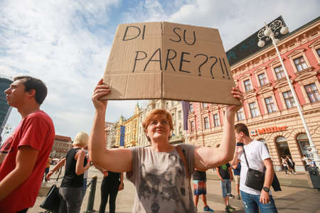 Zagreb, Croatia - 14. September, 2018 : Woman holding sign against against the ruling political party Hdz and the opposition SDP on the protest on Ban Jelacic Square in Zagreb, Croatia.のeditorial素材