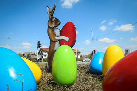 Velika Gorica, Croatia - 21 April, 2017 : A sculpture of a rabbit holding an Easter egg in its paws and surrounded by Easter eggs on the streets of Velika Gorica during Easter time.のeditorial素材