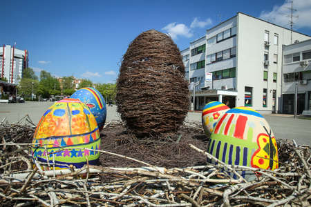 Velika Gorica, Croatia - 21 April, 2017 : A sculpture of a rabbit holding an Easter egg in its paws and surrounded by Easter eggs on the streets of Velika Gorica during Easter time.のeditorial素材