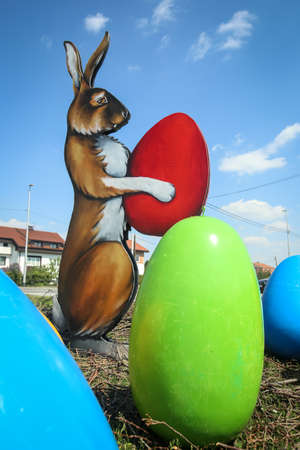 Velika Gorica, Croatia - 21 April, 2017 : A sculpture of a rabbit holding an Easter egg in its paws and surrounded by Easter eggs on the streets of Velika Gorica during Easter time.のeditorial素材