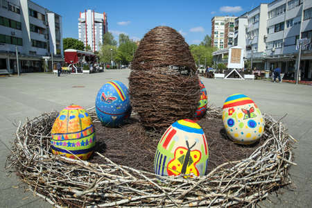 Velika Gorica, Croatia - 21 April, 2017 : A sculpture of a rabbit holding an Easter egg in its paws and surrounded by Easter eggs on the streets of Velika Gorica during Easter time.のeditorial素材