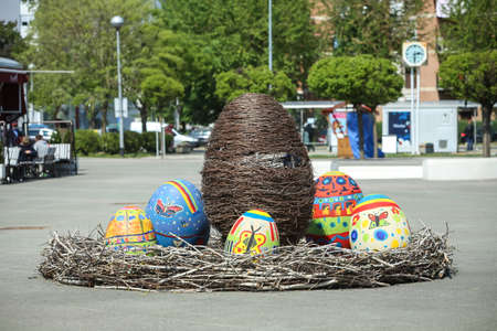 Velika Gorica, Croatia - 21 April, 2017 : A sculpture of a rabbit holding an Easter egg in its paws and surrounded by Easter eggs on the streets of Velika Gorica during Easter time.のeditorial素材