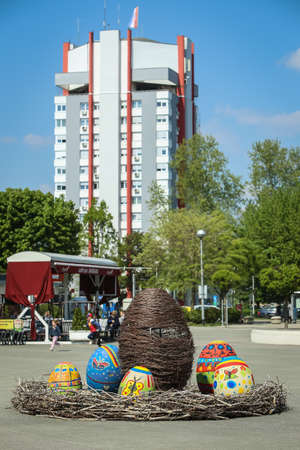 Velika Gorica, Croatia - 21 April, 2017 : A sculpture of a rabbit holding an Easter egg in its paws and surrounded by Easter eggs on the streets of Velika Gorica during Easter time.のeditorial素材