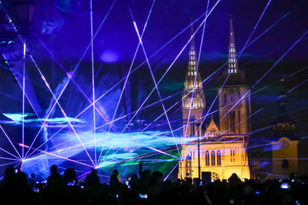 Zagreb, Croatia - 19 March, 2017 : Festival of lights in Zagreb, Croatia. People watch a laser show near Klovicevi dvori in the upper town with a view of the Zagreb Cathedral.のeditorial素材