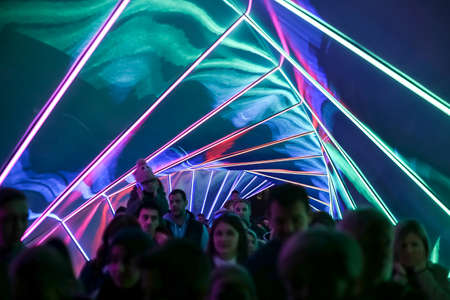Zagreb, Croatia - 19 March, 2017 : Festival of lights in Zagreb, Croatia. People walking through a lighted tunnel installation with colorful neon lights in the center of Zagreb.のeditorial素材