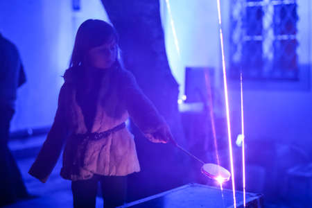Zagreb, Croatia - 19 March, 2017 : Festival of lights in Zagreb, Croatia. A young girl plays by interrupting laser beams in Zagreb, Croatia.のeditorial素材