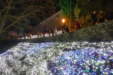 Zagreb, Croatia - 24 March, 2018 : People walking on illuminated park like flowers in a Vrazs promenade in upper town of Zagreb.のeditorial素材