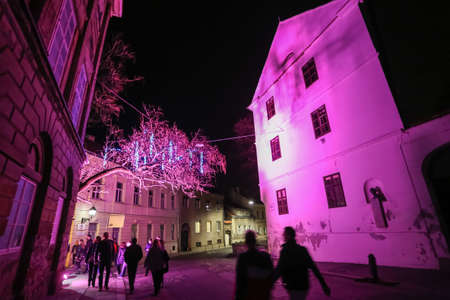 Zagreb, Croatia - 24 March, 2019 : People walking by illuminated building in the upper town during Festival of lights in Zagreb, Croatia.のeditorial素材