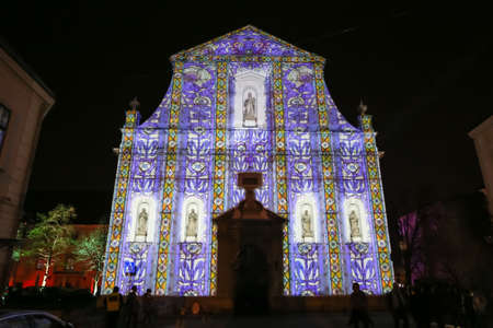 Zagreb, Croatia - 24 March, 2019 : Festival of lights in Zagreb, Croatia. People walking next to illuminated with a drawing church of St. Catherine in the upper town.のeditorial素材