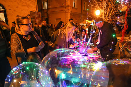 Zagreb, Croatia - 24 March, 2019 : People buying light props at the booth in the upper town during Festival of lights in Zagreb.のeditorial素材