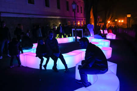 Zagreb, Croatia - 24 March, 2019 : People sitting on a light installation on the Strossmayer Promenade during Festival of lights in Zagreb.のeditorial素材