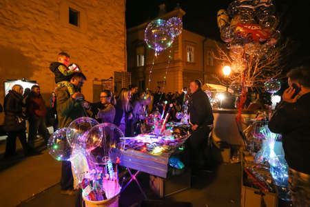 Zagreb, Croatia - 24 March, 2019 : People buying light props at the booth in the upper town during Festival of lights in Zagreb.のeditorial素材