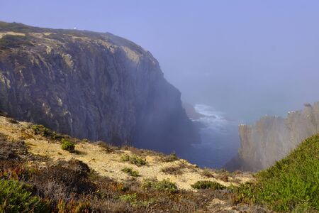Creek in the cliff shrouded in fogSolo Backpacker Trekking on the Rota Vicentina and Fishermen's...