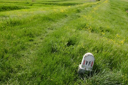 Sign on path in the green. Solo Backpacker Trekking on the Via Francigena from Lucca to Siena. Walking between nature, history, churches, 
ancient villages.の写真素材