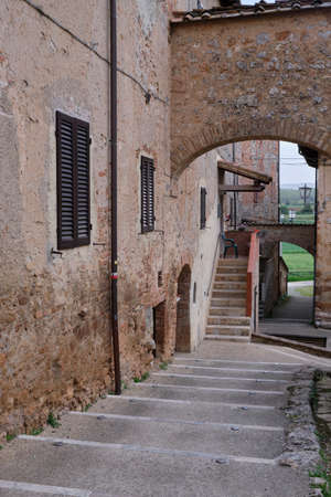 Old houses and staircase in Monteriggioni. Solo Backpacker Trekking on the Via Francigena from Lucca to Siena. Walking between nature, history, churches, ancient villages.のeditorial素材