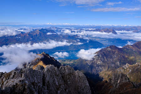 Solo Backpacker Trekking on the mountain in autumn trought foliage, lake, yellow, and orange colors