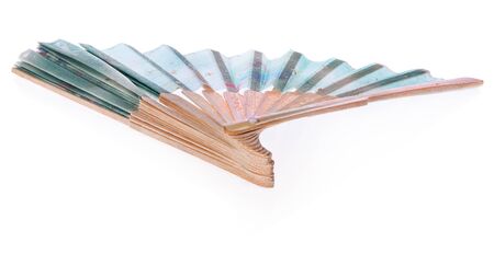Japanese fan decorated with flowers and stars in blue, green . The fan made of wooden spread on a white background.の写真素材