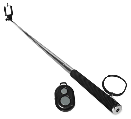 Selfie stick with remote control for taking pictures and videos. Silver monopod with black rubber handle. Hand holding smartphone on white background.の写真素材